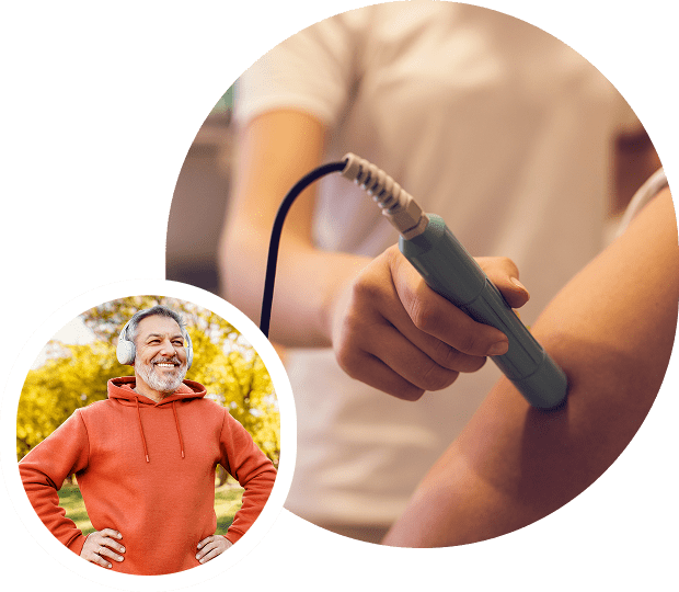 Man smiling, person using handheld device.