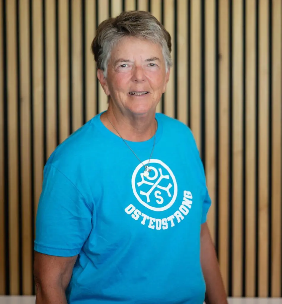 Person in blue Osteostrong t-shirt smiling.